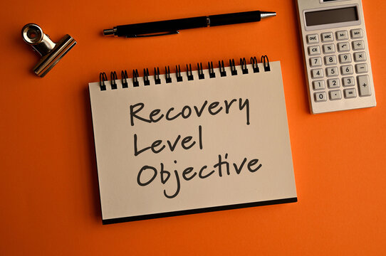 There is notebook with the word Recovery Level Objective. It is as an eye-catching image.