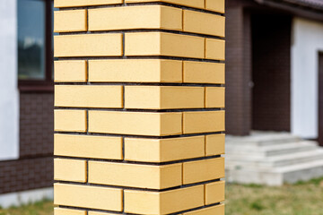 Fragment of a modern fence lined with decorative bricks in the old style
