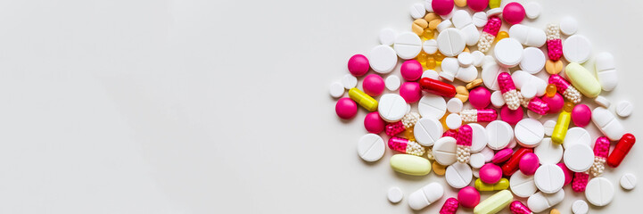 Pile of colorful medicine pills, vitamins on white background. top view.selective focus. Tablets pharmacy concept.drugs pills heap.Medication treatment, pharmacy and medicine.copy space