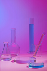 Podium in round shape for beauty product promotion. Laboratory glassware filled with colorful liquid displayed