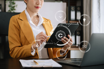 Copyright or patent concept, Person hand using laptop computer, tablet and smartphone with virtual screen copyright icon trademark, Creation ownership against piracy.