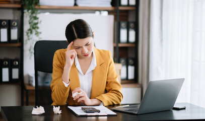 Fototapeta premium Woman who is tired and overthinking from working with tablet and laptop at modern office.