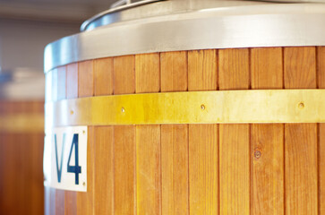 Brewery, keg and barrel for beer, alcohol and brewing process in warehouse. Wooden, drum and...