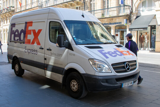 fedex express logo brand mercedes and text sign delivery panel van truck in city street deliver parcel