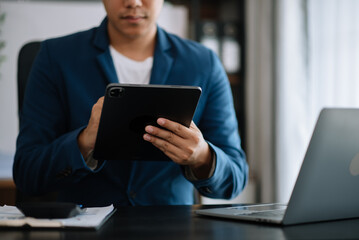 Businessman hand working digital marketing media in virtual screen with mobile phone and modern compute with diagram at office