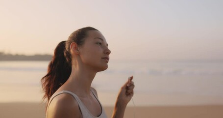 Female Runner Jogging With Earphones During Outdoor Workout on the
