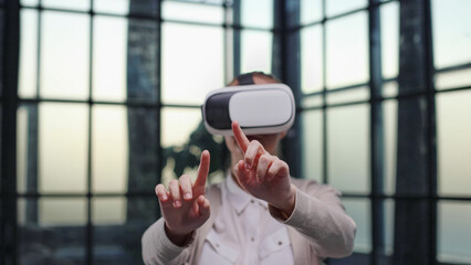 Office employee having fun at work, watching 3D video in virtual reality glasses