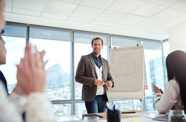 This is why hes our team leader. businesspeople applauding during a presentation in an office.
