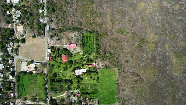 aerial drone shot of green grass hacienda and town of ake in yucatan