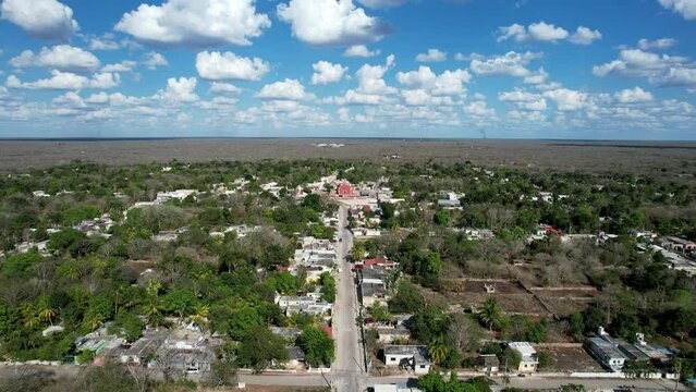 backwards drone shot of dar away ancient church at tahmek yucatan mexico during a very sunny day