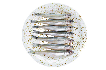 Raw smelt on a plate.  Isolated, transparent background