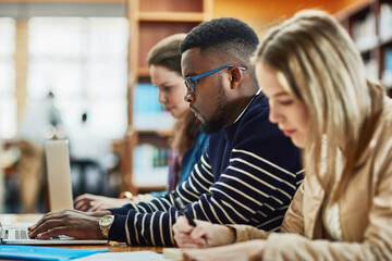 Working hard for the good of their future. a group of university students sitting in class at campus.