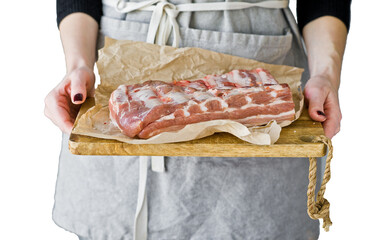 The chef holds pork ribs on a wooden cutting Board.  Isolated, transparent background