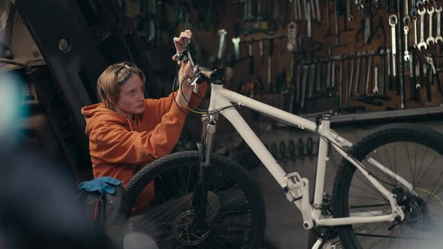 Precision and Focus: Teenager's Bike Repair Expertise in the Workshop