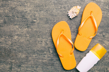 Flat lay composition with flip flops and seashell on colored background. Space for text top view