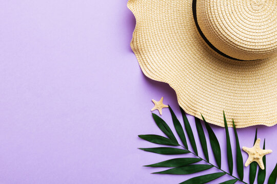 Summer holidays. Summer concept with straw hat and tropical leaf. Flat lay, top view, copy space