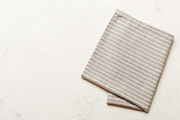 top view with gray kitchen napkin isolated on table background. Folded cloth for mockup with copy space, Flat lay. Minimal style