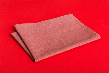 top view with red empty kitchen napkin isolated on table background. Folded cloth for mockup with copy space, Flat lay. Minimal style