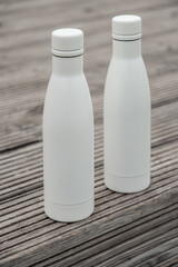 metal thermos bottle white color minimalism wooden background