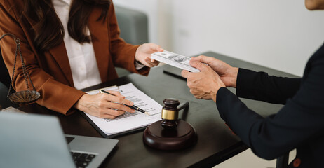 justice and law concept.passing bribe money in the envelop at office. businessman hand taking bribe...