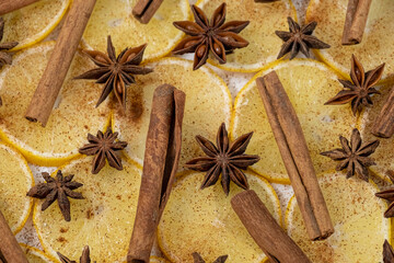 Lemon slices, star anise, cinnamon sticks close-up, food background. Juicy citrus fruits and...