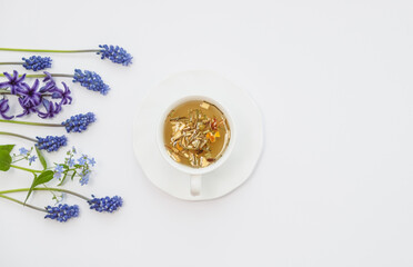 Obraz na płótnie Canvas Tea Time: Relaxing with herbal tea with healing properties. Drink with natural herbs. Floral tea arrangement. Nature's remedy aromatic herbal tea with healing herbs and flowers top view vertical