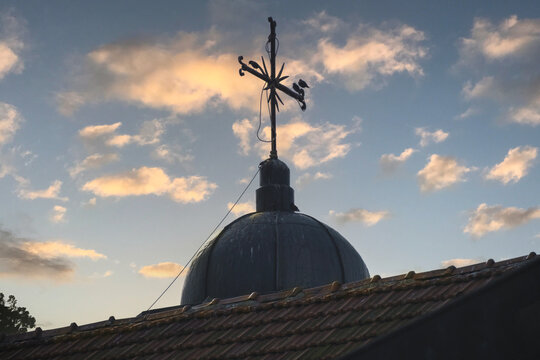 Lightning rod and birds. Roof of a building. reverse light. 