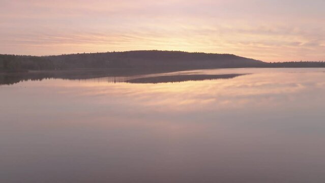 Sunrise over Monson Pond on a flat calm morning 