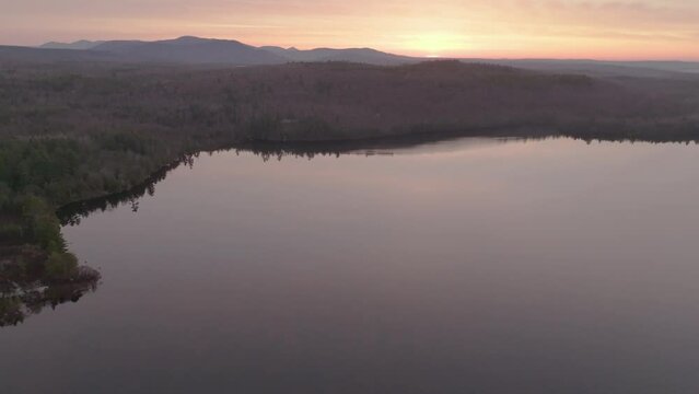 Golden Hour light over Monson Pond Ascending Aerial 