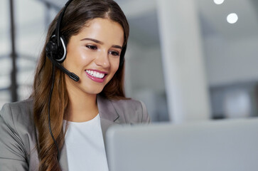 Going the extra mile is never an effort for her. a young call centre agent working in an office.