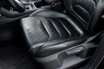 Modern luxury car black leather with alcantara interior. Part of black leather car seat. Interior of prestige car. Leather seats isolated. - obrazy, fototapety, plakaty
