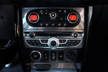Car climate control. Detail air conditioning button inside a car. Car interior detail. Modern vehicle multimedia. Closeup image of air control panel inside of the car.