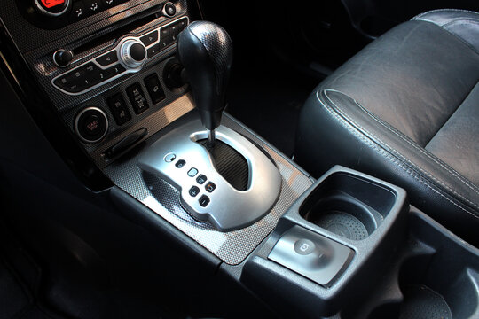 Selector automatic transmission with leather in the interior of a modern car. Close up detail of gear knob. Black leather car interior close up. Right view.