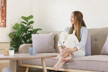 Rest time concept, Women are sitting on comfortable couch and looking outside to thinking something