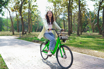 Women riding bicycle with having fun to relaxation and exercise for healthy lifestyle in the park