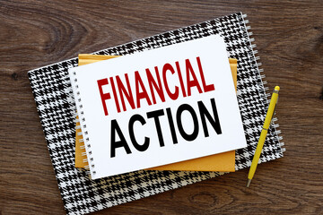 Financial Action dark wooden background with text on paper. yellow notepad