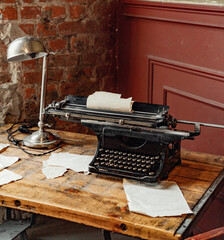 The workplace of a writer or journalist. A vintage typewriter stands on an old wooden table.