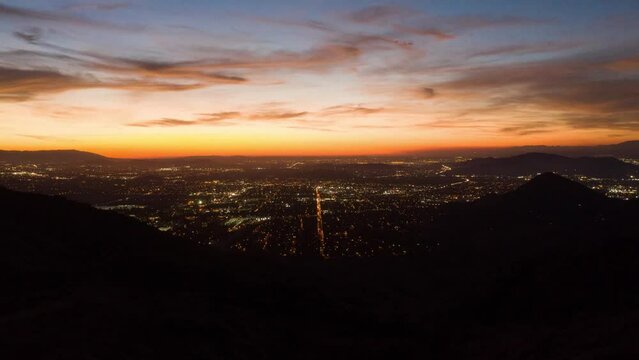 Timelapse of city scape with lights of the city and a great sunset
