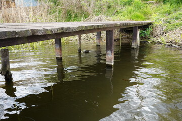 A wooden dock in a lake. Bottom view of the jetty at the lake.