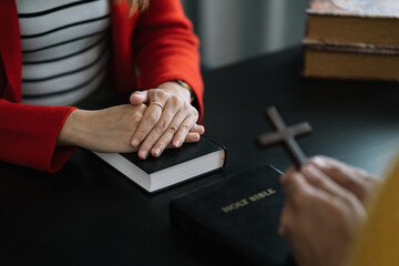 Asian men and women hands praying to god with the bible. Pray for god blessing. Religious beliefs Christian life crisis prayer to god.