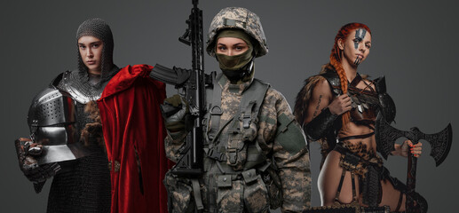 Fototapeta premium Studio shot of female soldier holding rifle with ancient amazon and knight woman.