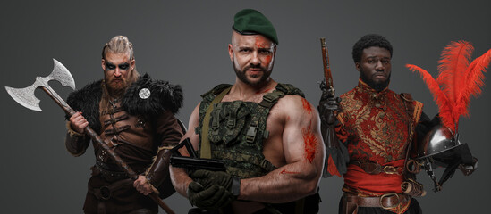 Studio shot of special forces soldier with nordic warrior and black conquistador.