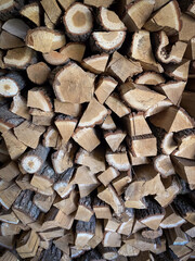 Stacked chopped firewood refers to a pile of cut and split logs that have been neatly arranged in a vertical fashion, one on top of the other, forming a sturdy and organized structure.