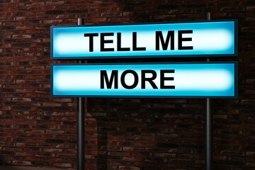 Obraz premium Tell me more. Black letters on a light box. Illuminated sign in front of a red brick wall. Talking, feedback, communication, evidence, education, advice and request. 3D illustration
