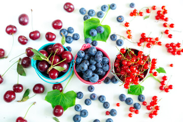 Mix of fresh berries in small buckets. Juicy summer wallpaper.