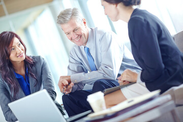 Chatting about their strategy. Three businesspeople sitting together and working as a team.