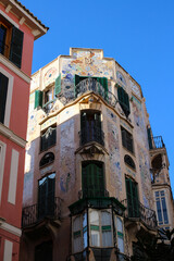 Residential building with green shutters, decorated with mosaics on the street of Palma de Mallorca. Majorca. Spain.