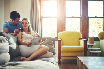 Online is the only place we enjoy shopping together. a young couple doing some online shopping on a digital tablet.