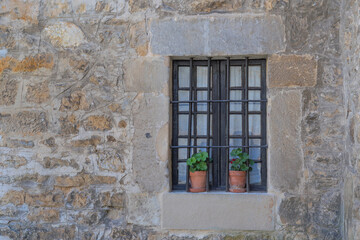 stone facade of a rural house with window