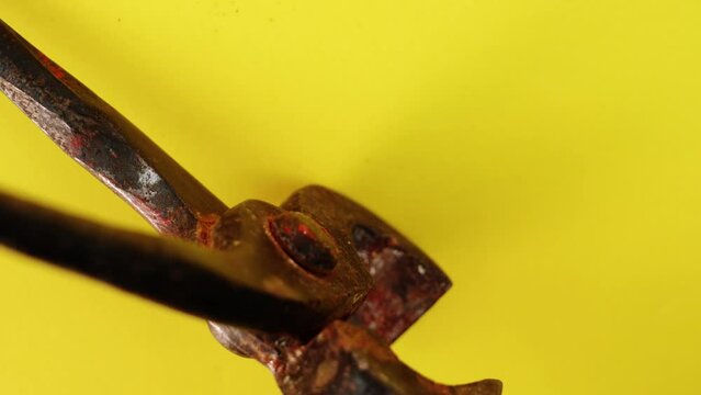 Motion past old metal end cutting pliers with brown rust